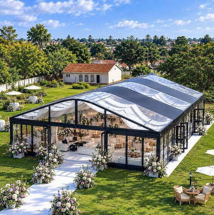 Glass marquee reception with a floral walkway by Top-Notch Venue Concept